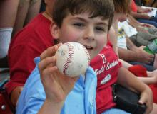 Boy sitting three seats over from us, catches a Manny Ramrez ball.